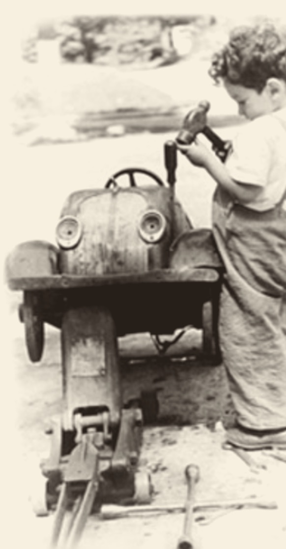 Martin Richter working on a pedal car, 1941